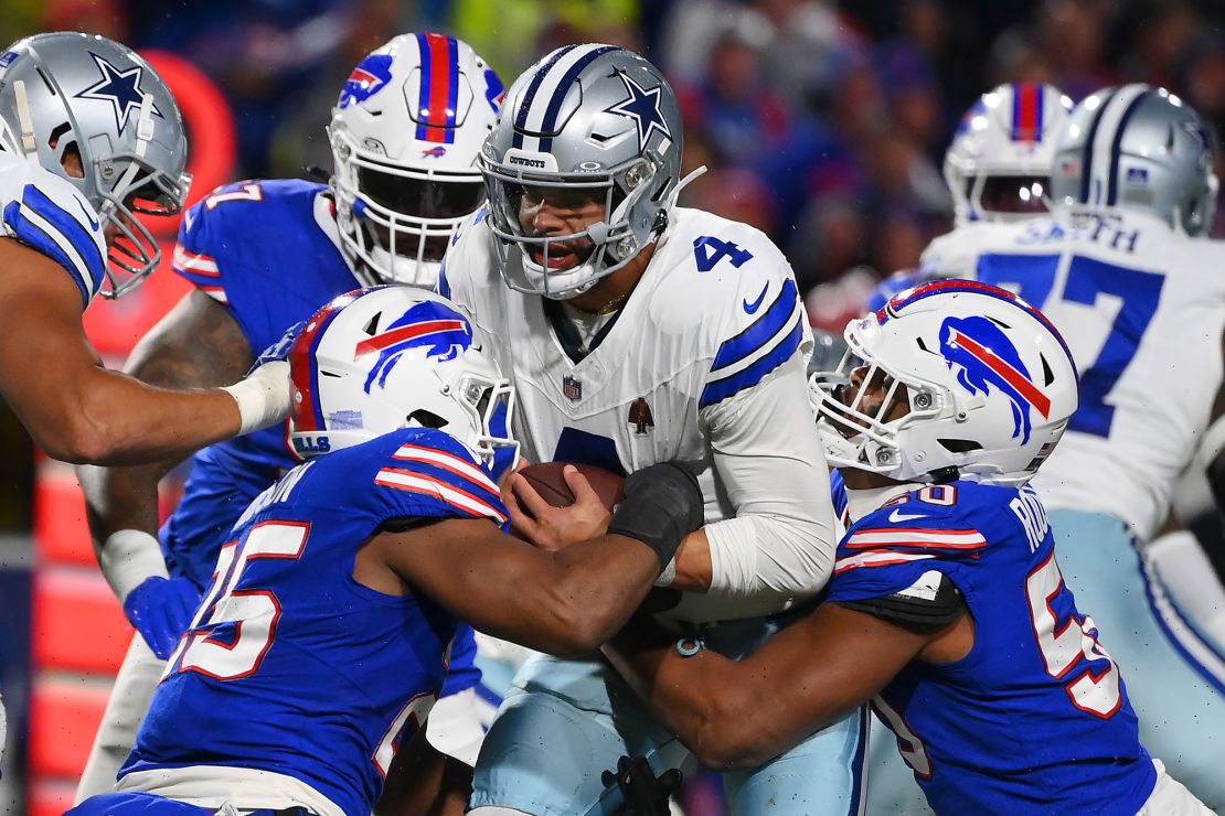 ORCHARD PARK, NEW YORK - DECEMBER 17: Tyrel Dodson #25 and Greg Rousseau #50 both of the Buffalo Bills sack Dak Prescott #4 of the Dallas Cowboys during the third quarter at Highmark Stadium on December 17, 2023 in Orchard Park, New York. (Photo by Rich Barnes/Getty Images)