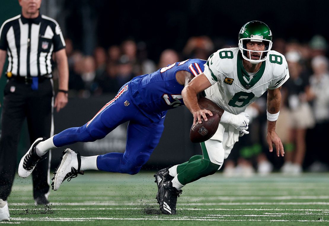 EAST RUTHERFORD, NEW JERSEY - SEPTEMBER 11: Aaron Rodgers #8 of the New York Jets is sacked by Leonard Floyd #56 of the Buffalo Bills in the first quarter at MetLife Stadium on September 11, 2023 in East Rutherford, New Jersey. Rodgers was helped off the field after this play. (Photo by Elsa/Getty Images)