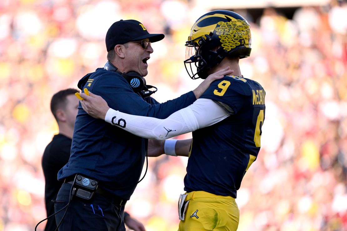 Michigan head coach Jim Harbaugh, left, celebrates with quarterback J.J. McCarthy (9) after a touchdown catch by running back Blake Corum during the first half of the Rose Bowl CFP NCAA semifinal college football game against Alabama Monday, Jan. 1, 2024, in Pasadena, Calif.