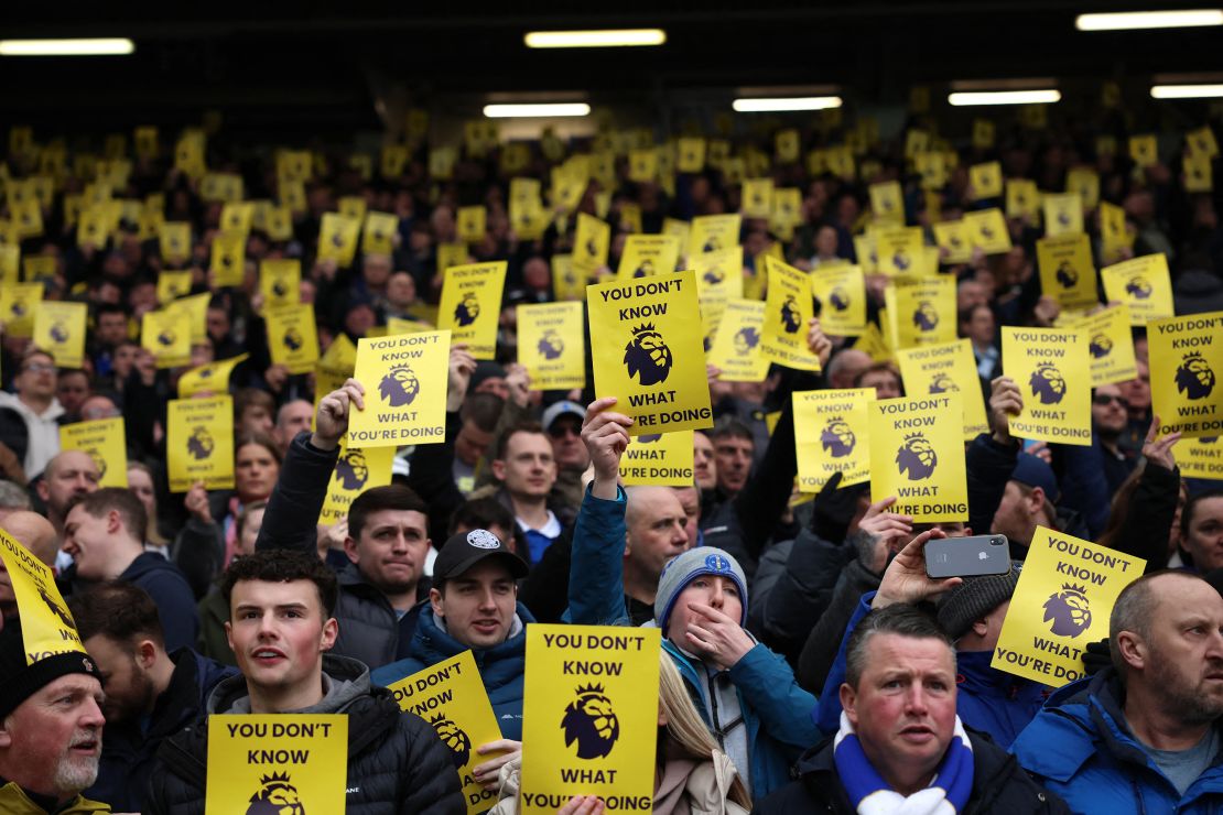 Everton fans hold up a sign in protest of the Premier League's decision to penalize the club for breaching financial regulations.