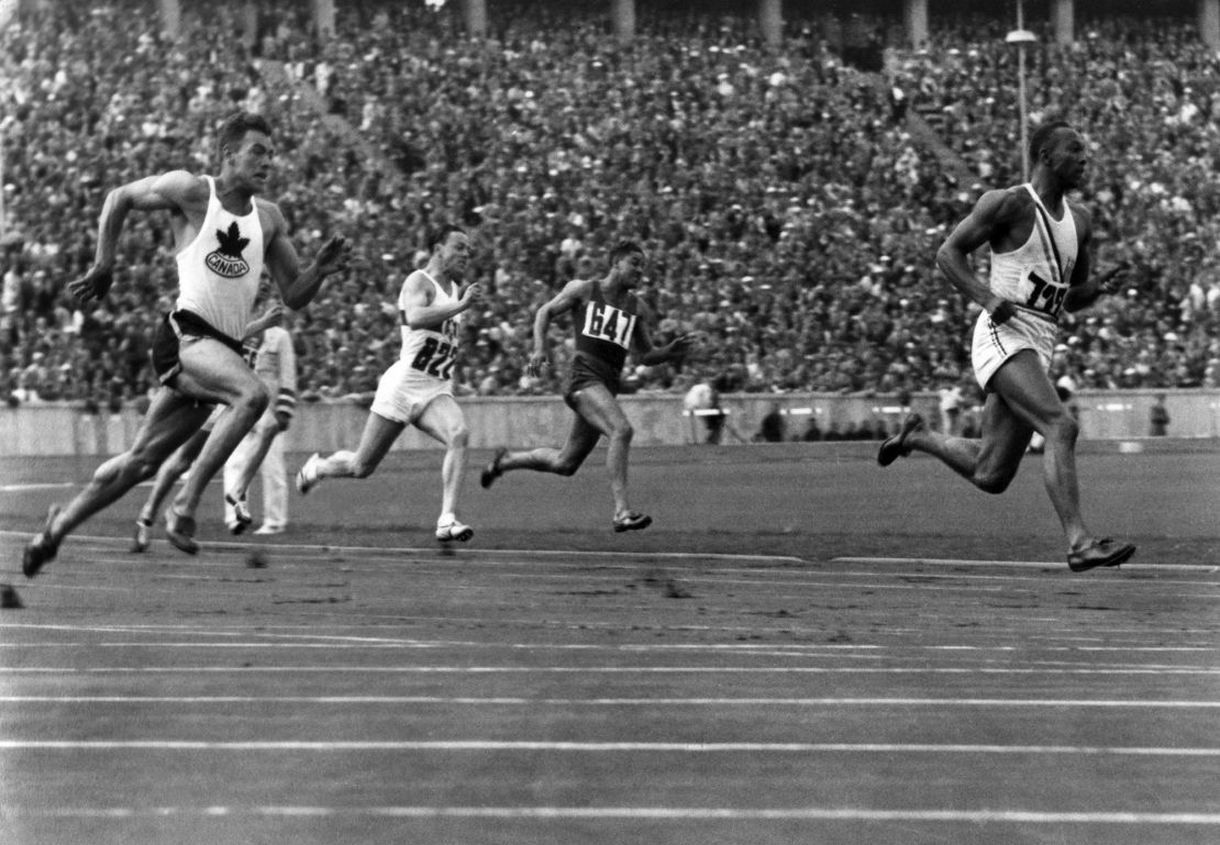 Owens (right) competes in the 200m preliminary heats at the 1936 Olympic Games.