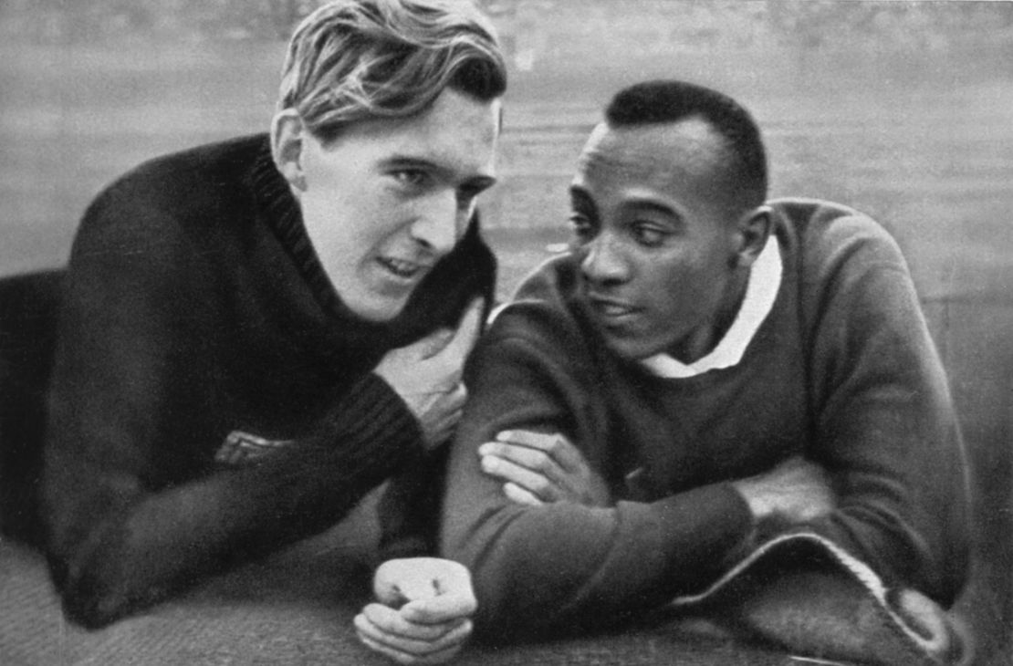 Owens (right) and Long (left) talk ahead of the long jump at the 1936 Berlin Olympics.