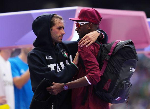 Italian high jumper Gianmarco Tamberi, left, speaks with Qatar's Mutaz Essa Barshim during the qualification round on August 7. The two shared a gold medal in the event three years ago in Tokyo. When Barshim pulled up with an apparent injury in Paris, <a href=