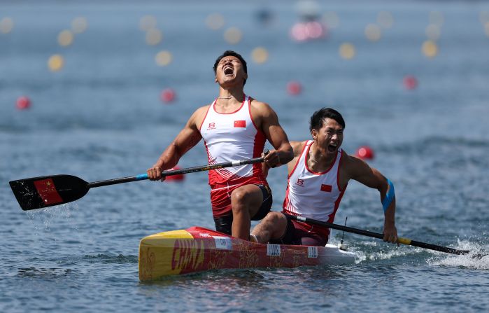 Chinese canoeists Liu Hao and Ji Bowen celebrate after winning a doubles gold medal on August 8.