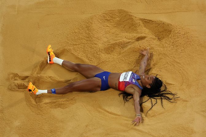 American long jumper Tara Davis-Woodhall celebrates in the sand <a href=