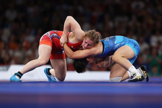 The United States' Amit Elor, left, wrestles Kyrgyzstan's Meerim Zhumanazarova in the 68-kilogram final on August 6. <a href=