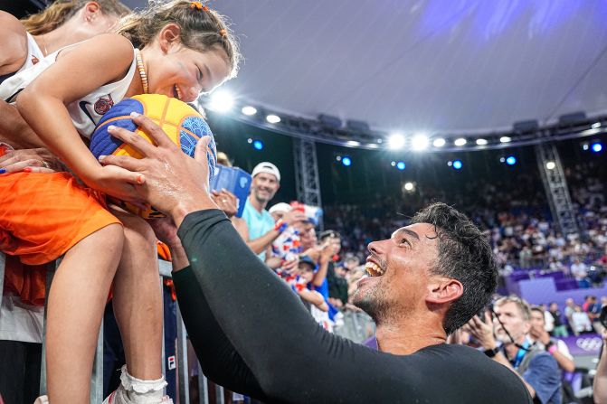 A fan receives a signed ball from Arvin Slagter of the Netherlands after <a href=