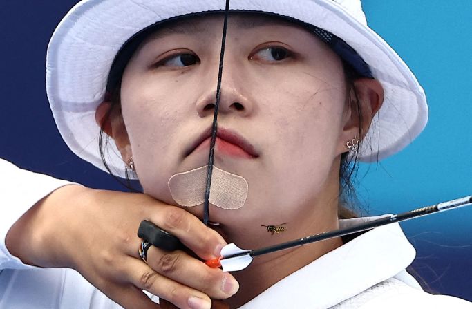 A bee flies near South Korean archer Lim Si-hyeon on August 3. <a href=