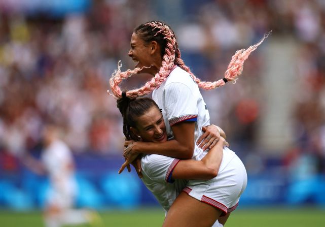 US forward Trinity Rodman, right, celebrates with teammate Emily Fox after scoring a goal against Japan on August 3. The Americans needed extra time to win 1-0 and <a href=