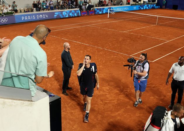 A tearful Andy Murray leaves the court after he and doubles partner Dan Evans <a href=