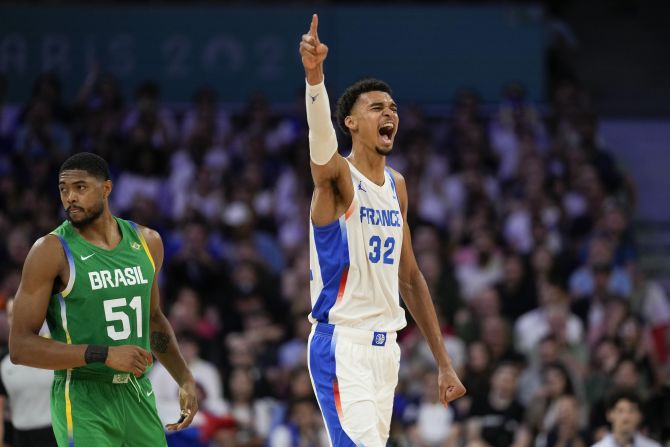 French basketball superstar Victor Wembanyama celebrates a Brazil turnover during the teams' opening game on July 27. Wembanyama had 19 points, nine rebounds, two assists, four steals and three blocks as <a href=