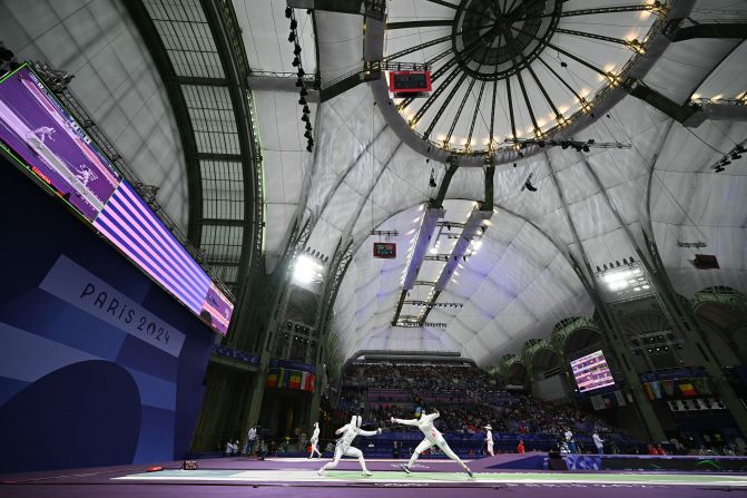 Japanese fencer Miho Yoshimura, left, competes against Rwanda’s Tufaha Uwihoreye in an épée round-of-64 bout on July 27. The Grand Palais, an exhibition hall and event center located off the Champs-Élysées, <a href=