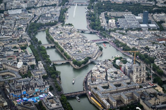 This aerial photo shows the Notre Dame cathedral as boats pass by on the Seine. As part of the opening ceremony, <a href=