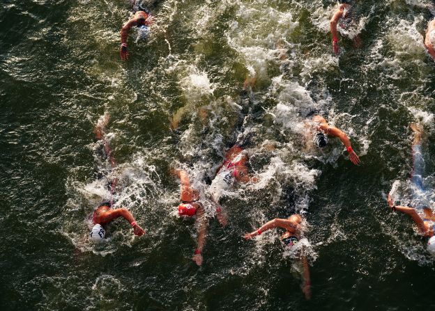 Competitors swim in the Seine River during the women's 10-kilometer marathon on August 8. The water quality of the river has been an <a href=