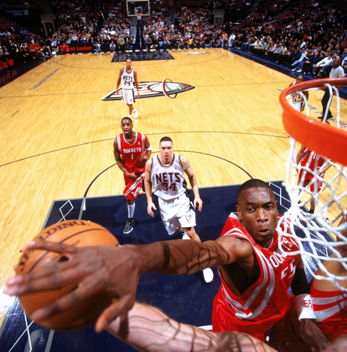 Dikembe Mutombo, playing for the Houston Rockets, blocks a shot during a game in East Rutherford, New Jersey, in 2004.