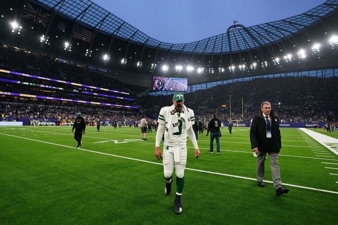 New York Jets quarterback Aaron Rodgers walks off the field after <a href=