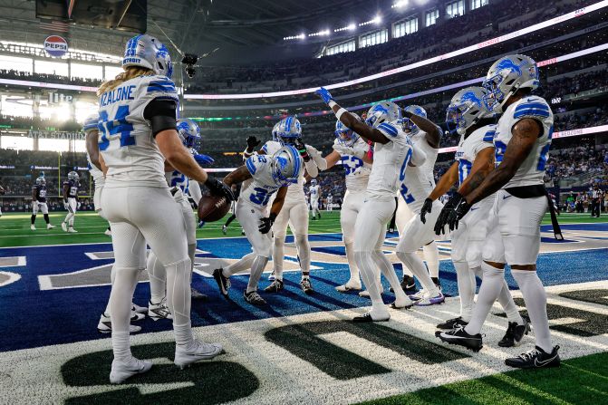 Detroit Lions safety Brian Branch, center, celebrates an interception with his teammates during a game against the Dallas Cowboys in Arlington, Texas, on Sunday, October 13. The Lions trounced the Cowboys 47-9.